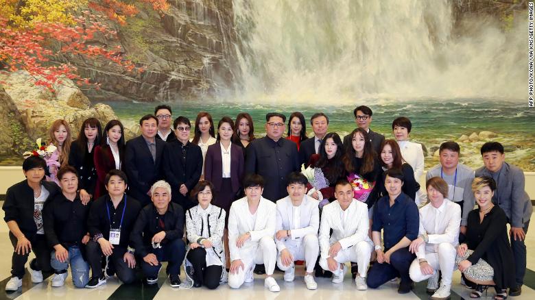 Kim Jong Un and his wife Ri Sol Ju pose with South Korea&#39;s Culture, Sports and Tourism Minister Do Jong-whan and South Korean musicians in this image released by KCNA. 