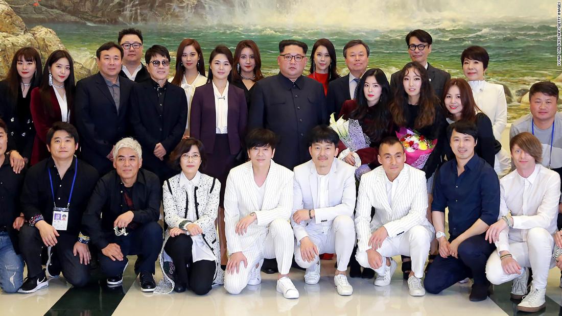 Ri and Kim pose for a photo on April 1, 2018 alongside South Korea&#39;s Culture, Sports and Tourism Minister Do Jong-whan (third line, third from right) and South Korean musicians after a rare concert by South Korean musicians at the 1,500-seat East Pyongyang Grand Theater in Pyongyang.