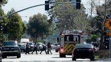 Officers walk near a YouTube office in San Bruno, Calif., Tuesday, April 3, 2018. Police in Northern California are responding to reports of a shooting at YouTube headquarters in the city of San Bruno. (AP Photo/Jeff Chiu)