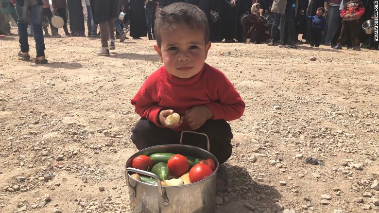A boy from Eastern Ghouta shows his family&#39;s daily pot of food.