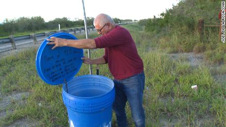 Eddie Canales, director of the South Texas Human Rights Center, checks a water station on a migrant route in Falfurrias, Texas.