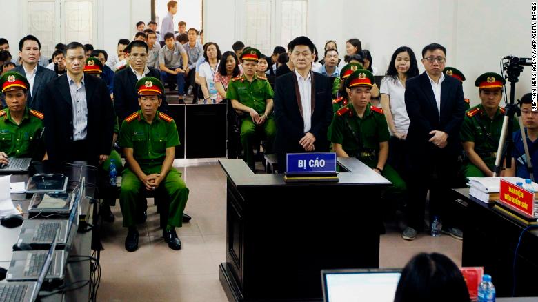 Lawyer Nguyen Van Dai (center) and other political activists stand in a courtroom during their trial in Hanoi on April 5.