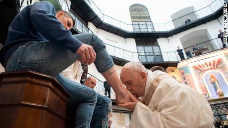 Seeing Francis wash  the feet of inmates on Holy Thursday can compel people into acts of kindness, scholars say. 