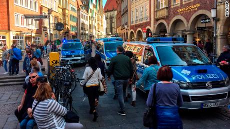 Police vans stand in downtown Muenster, Germany, Saturday, April 7, 2018. German news agency dpa says several people killed after car crashes into crowd in city of Muenster.  (dpa via AP)