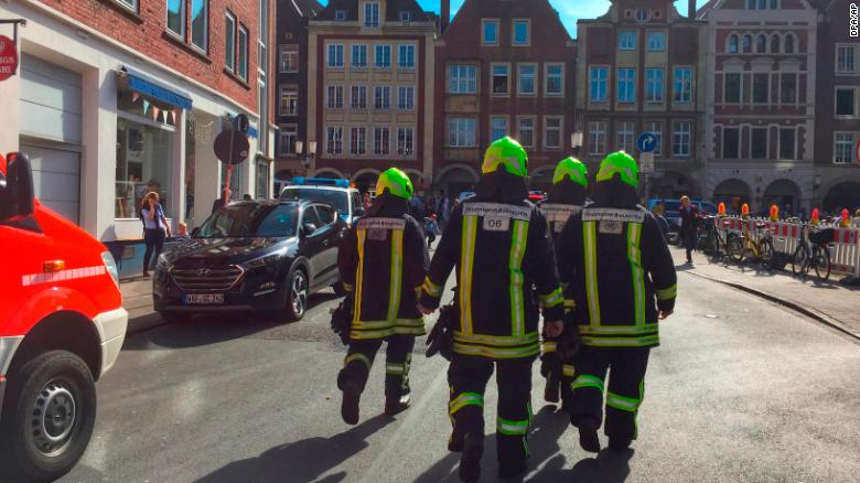 Firefighters walk through downtown Muenster, Germany, on Saturday after a vehicle drove into a crowd. 