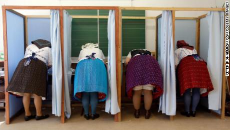 Women dressed in traditional Hungarian outfits cast their votes.  