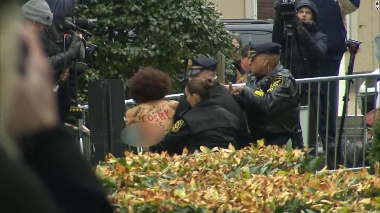 Topless woman arrested outside Cosby trial