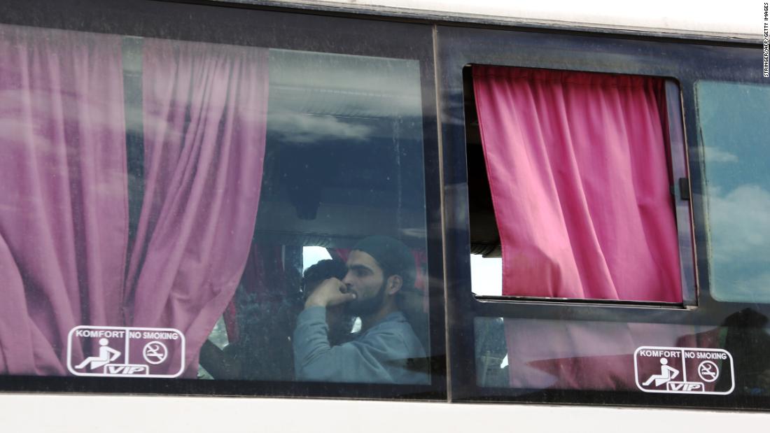 A Syrian man is seen aboard a bus carrying fighters and their families from their former rebel bastion of Douma as they arrive at the Syrian government-held side of the Wafideen checkpoint on the outskirts of Damascus.