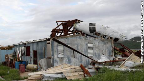 The wreckage of a plane lies on the roof of a destroyed building in Tortola, British Virgin Islands. 