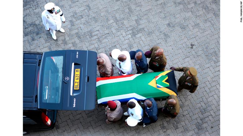 The flag-draped casket carrying Winnie Madikizela-Mandela&#39;s remains arrives Saturday, April 14, 2018, at Orlando Stadium in Johannesburg, South Africa.
