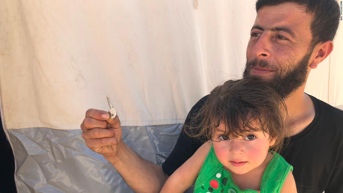 Walid Dervish, 23, pictured with his daughter, says he brought his Douma house keys with him to the refugee camp. &quot;Maybe one day I can go back,&quot; he said. 