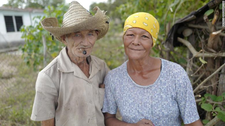 A couple in Céspedes, Cuba, pose in front of their home. After he took power in 1959, Fidel Castro promised to improve the lives of people living in Cuba&#39;s poverty-stricken countryside. He oversaw literacy and electrification campaigns and built hospitals for the rural poor. In recent decades, though, many Cubans living in the countryside have moved to cities, seeking better housing conditions and more economic opportunities.