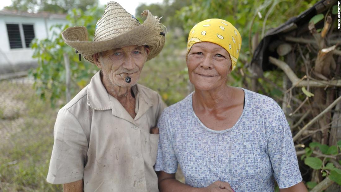 A couple in Céspedes, Cuba, pose in front of their home. After he took power in 1959, Fidel Castro promised to improve the lives of people living in Cuba&#39;s poverty-stricken countryside. He oversaw literacy and electrification campaigns and built hospitals for the rural poor. In recent decades, though, many Cubans living in the countryside have moved to cities, seeking better housing conditions and more economic opportunities.