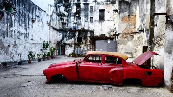 An American car from the 1950s rots in the run-down neighborhood of Centro Habana. Transportation and housing are in short supply in Cuba. Most Cubans still work for the state and barely earn enough to live on, much less afford a luxury item like a car or a better place to live. Cuban officials blame the US trade embargo for Cuba's economic woes. Critics say government inefficiency and poor planning have kept wages low.