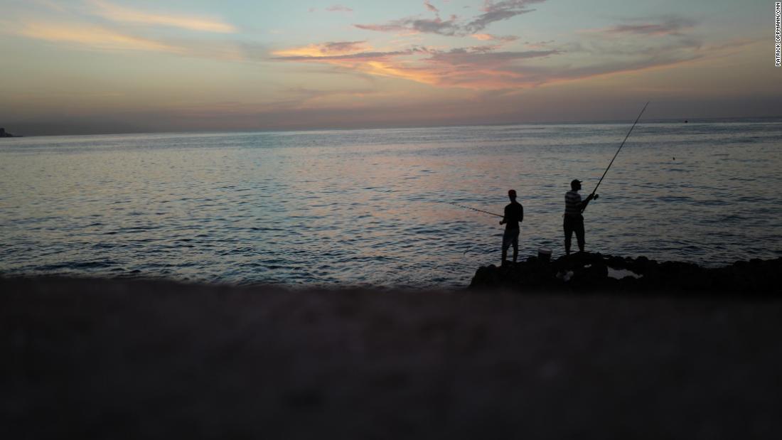 Cubans fish off Havana&#39;s Malecón seawall at sunset. The wall has been used during the years by Cubans launching small boats to attempt the dangerous journey across the Straits of Florida to the United States. Cubans who reached the US were allowed to stay there under the so-called &quot;wet foot, dry foot&quot; law that gave Cubans special immigration status. But in 2017, President Obama ended that policy and Cubans who reach the US are now being sent back to the island.