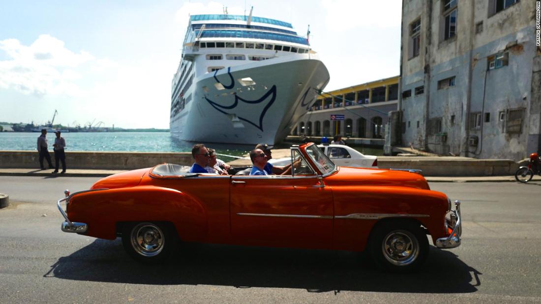 A classic American car rolls by the first American cruise ship to visit Cuba in decades. In 2016 the US restarted regular cruise ship service to the island, and for the first time since the Cuban revolution, US visitors came to Cuba in large numbers. Americans are still restricted to &quot;permitted&quot; forms of travel to the island, and President Donald Trump has enacted restrictions on where Americans can stay and spend money, to prevent their dollars from going into the pocket of the Cuban military.