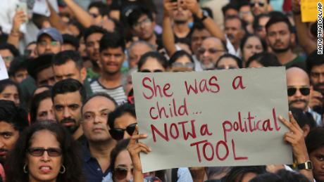 A participant holds a placard during a protest against recent incidents of rape in the country, in Mumbai, India, Sunday, April 15, 2018. 