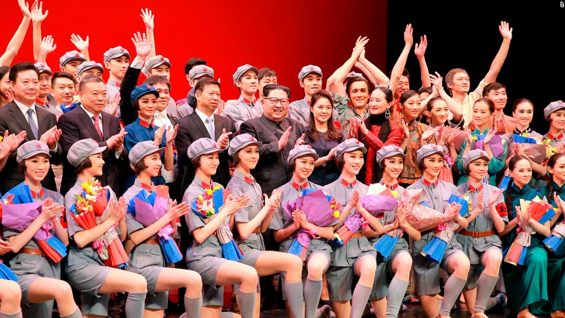 Kim and Ri pose alongside Chinese official Song Tao (left of Kim) on April 16, 2018 with members of a Chinese art troupe at the East Pyongyang Grand Theater in Pyongyang.