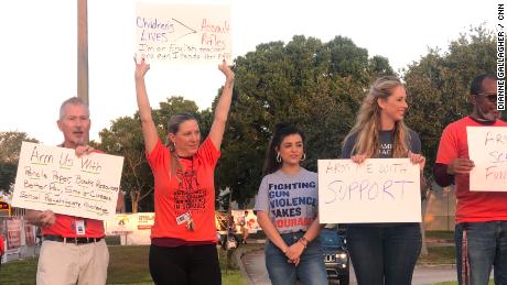 Teachers at Florida&#39;s Marjory Stoneman Douglas High School demonstrate outside the school before classes ahead of students&#39; National School Walkout relating to gun reform on Friday, April 20, 2018.