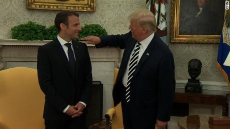 Trump jokingly brushes &#39;dandruff&#39; off Macron