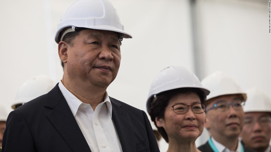 China&#39;s President Xi Jinping (left) and Hong Kong&#39;s chief executive Carrie Lam (center) in Hong Kong, watching a presentation during a visit to the Hong Kong-Zhuhai-Macau bridge on July 1, 2017. 