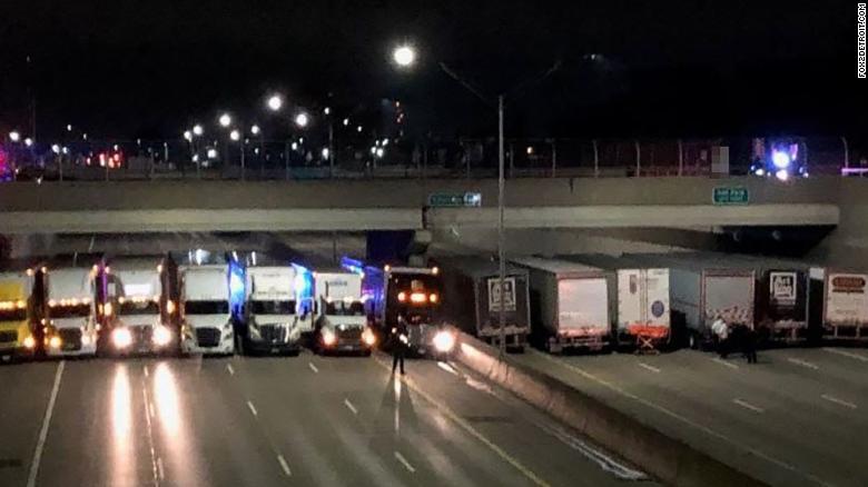 Detroit truckers line up under a freeway overpass to help a suicidal man.