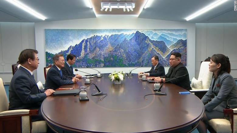 Kim Jong Un and Moon Jae-in sit opposite each at the negotiating table at the Peace House in the demilitarized zone, 