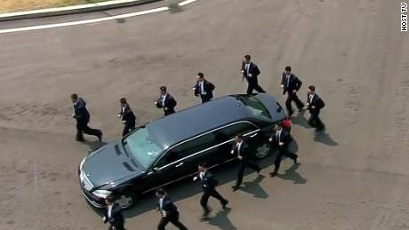 See Kim&#39;s security guards run alongside limo