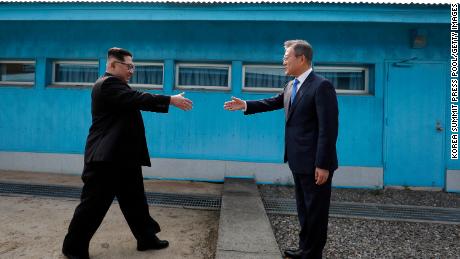 North Korean Leader Kim Jong Un (left) and South Korean President Moon Jae-in (right) shake hands over the military demarcation line that divides the demilitarized zone upon meeting for the inter-Korean Summit on Friday.