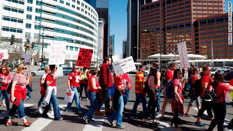 Teachers march on  Broadway in Denver on Friday. 