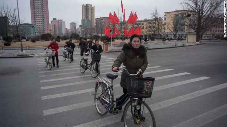 Cyclists cross a road in Kaesong, North Korea. A joint industrial complex once run in the city by the South and North Korean has been considered a possible model for future ties.