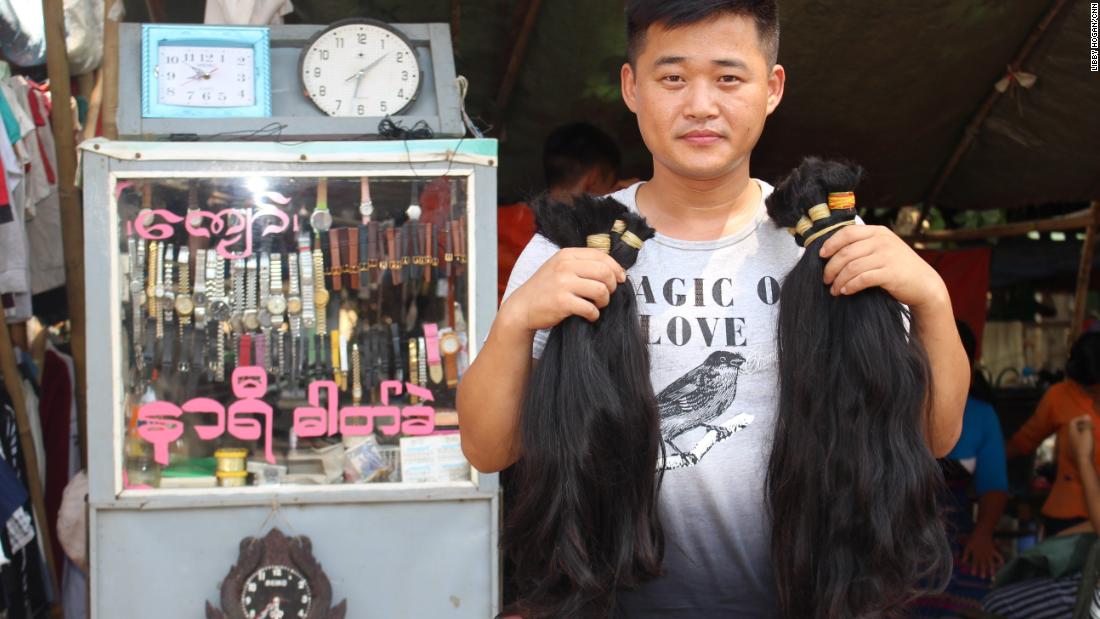 A hair buyer from China with bunches of hair he has bought from Yangon&#39;s Insein market. 