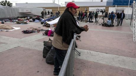 A Central American migrant   waits to be received by US authorities outside &quot;El Chaparral&quot; port of entry in Tijuana.