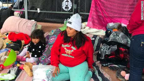 Sarae Carillo with her daughter Daryelen, 2, wait on the Mexican side of the border.
