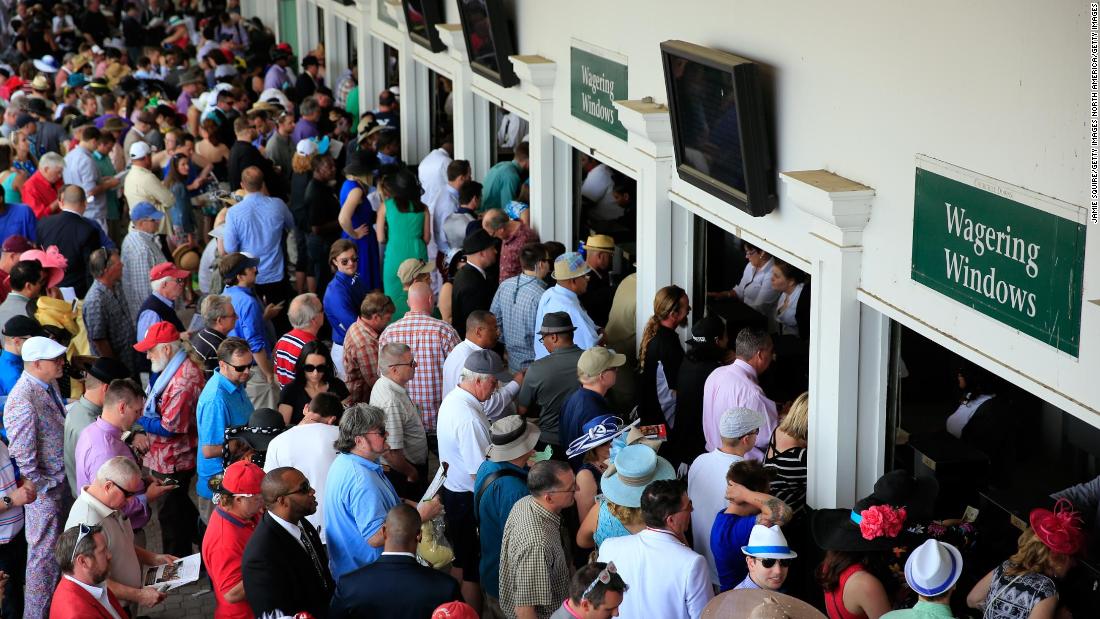 Punters prepare to place their bets at the wagering windows in 2014. 