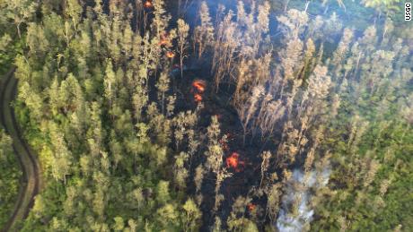 Smoke and lava can be seen on the ground following the eruption of Hawaii&#39;s Kilauea volcano on Thursday, May 3, 2018.