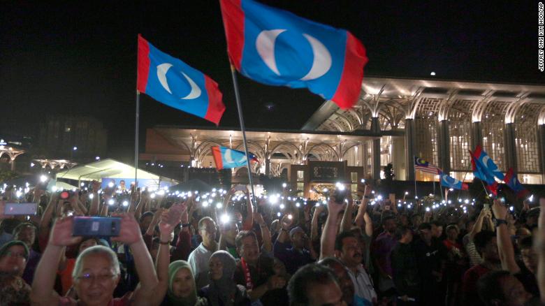 Supporters wave opposition party flags during an election campaign rally organized by Mahathir Mohamad, Putrajaya, Malaysia, May 3.
