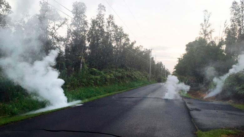 Steam rises from cracks in the road near Leilani Estates on Friday.