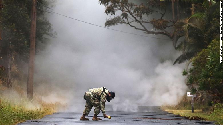 Army National Guard First Lt. Aaron Hew Len takes measurements for sulfur dioxide gas at volcanic fissures in the Leilani Estates neighborhood.