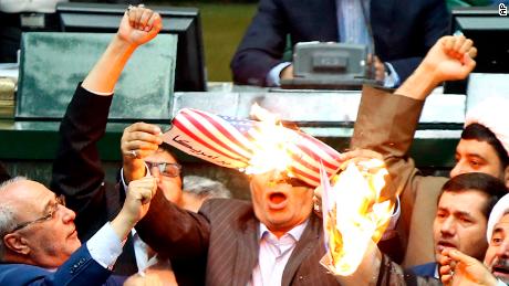 Iranian lawmakers burn two pieces of papers representing the U.S. flag and the nuclear deal as they chant slogans against the U.S. at the parliament in Tehran, Iran, Wednesday, May 9, 2018. Iranian lawmakers have set a paper U.S. flag ablaze at parliament after President Donald Trump&#39;s nuclear deal pullout, shouting, &quot;Death to America!&quot;. President Donald Trump withdrew the U.S. from the deal on Tuesday and restored harsh sanctions against Iran. (AP Photo)