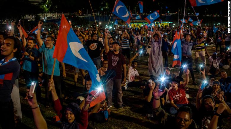 Supporters of Mahathir Mohamad, cheer as they watch live televised result announcement of the 14th general elections on May 10, 2018 in Kuala Lumpur, Malaysia.