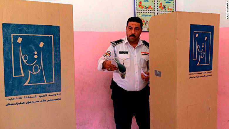 An Iraqi traffic policeman prepares to vote in Baghdad on May 10. Members of the security forces cast ballots before other voters.