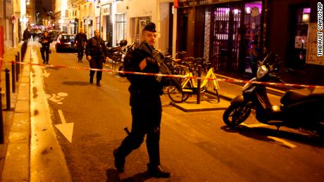 A police officer cordons off the area after a knife attack in central Paris, Saturday May 12, 2018. The Paris police said the attacker was subdued by officers during the stabbing attack in the 2nd arrondissement or district of the French capital Saturday. (AP Photo/Thibault Camus)