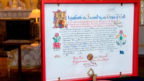 The &#39;Instrument of Consent&#39;, which is the Queen&#39;s historic formal consent to Prince Harry&#39;s forthcoming marriage to Meghan Markle, photographed at Buckingham Palace in London, Friday May 11, 2018.  Britain&#39;s Queen Elizabeth II signed, top right, the Instrument of Consent, her formal notice of approval for the wedding in elaborate calligraphic script issued under the Great Seal of the Realm.(Victoria Jones/Pool via AP)