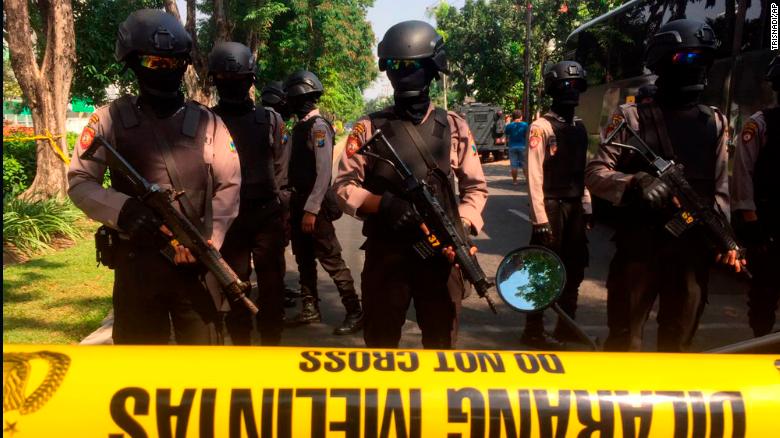 Police officers near the scene of hte blast at Santa Maria church in Surabaya, East Java, Indonesia.