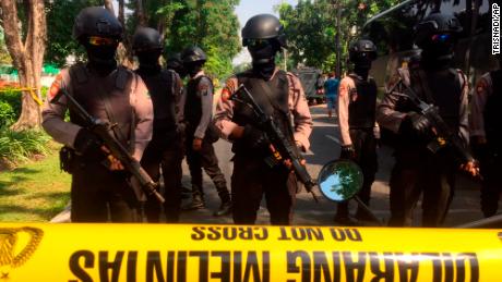 Police officers near the scene of hte blast at Santa Maria church in Surabaya, East Java, Indonesia.