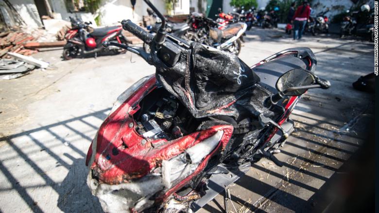 A damaged motorcycle is seen outside the Surabaya Centre Pentecostal Church in Surabaya on May 14.