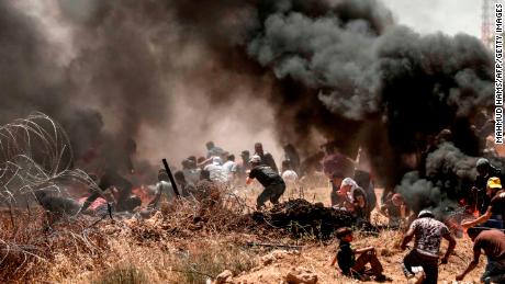 Palestinians clash with Israeli forces near the frontier between Gaza and Israel on May 14. 