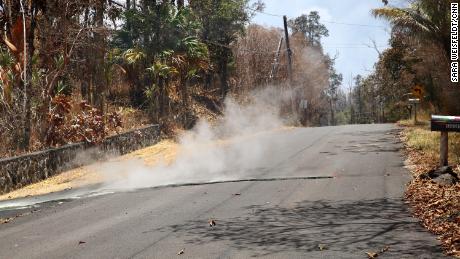 Toxic sulfur dioxide seeps out of a street in Leilani Estates, Hawaii.