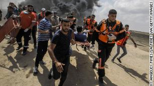 Israel defends Gaza crackdown as Palestinians bury their dead 